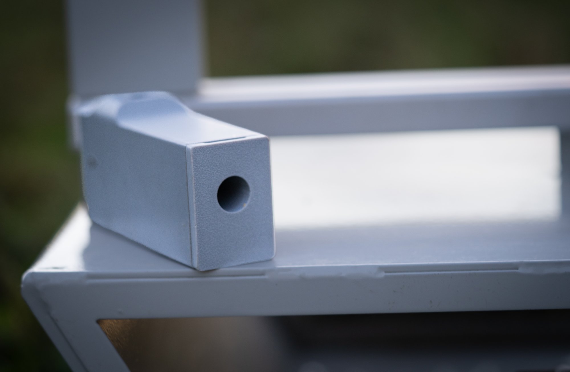 GTS Motion Sensor resting on the powder-coated GTS Pivot base